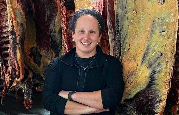 Katie Adkins stands with cuts of meat