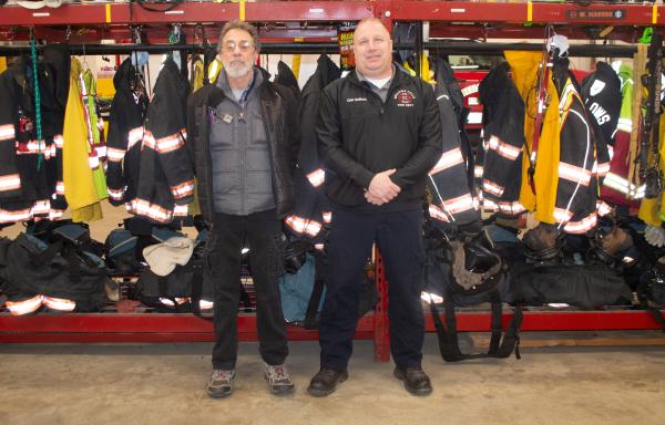 Gary Fox with the town of Rockingham and Bellows Falls Fire Chief Shaun McGinnis stand next to firefighter gear